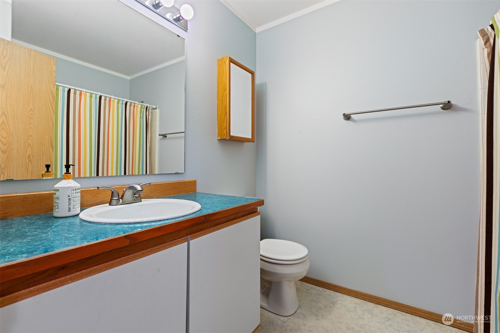 1117 58th Place Southwest Everett, WA 98203 - Photo 12 of 25 a bathroom with a granite countertop sink and a mirror
