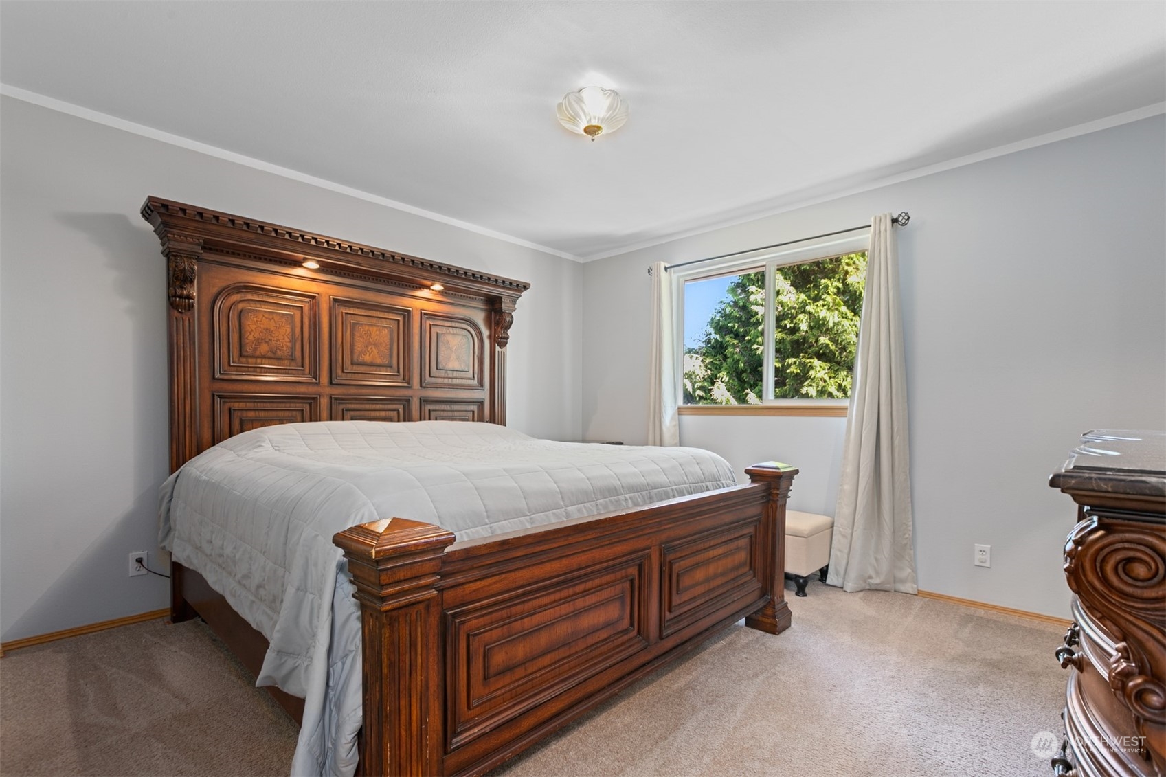 1117 58th Place Southwest Everett, WA 98203 - Photo 13 of 25 a bed sitting in a bedroom next to a window