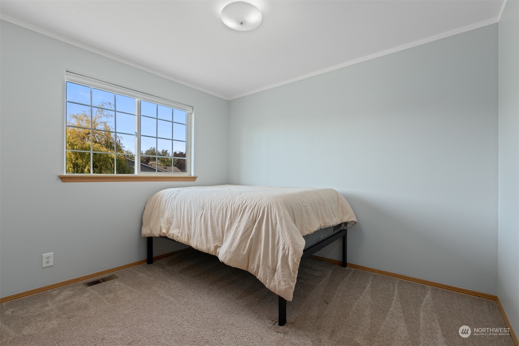 1117 58th Place Southwest Everett, WA 98203 - Photo 15 of 25 a bed sitting in a bedroom next to a window