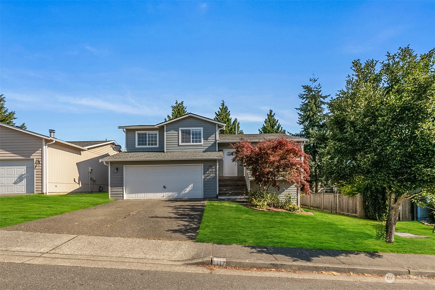 1117 58th Place Southwest Everett, WA 98203 - Photo 25 of 25 a front view of a house with a garden and trees