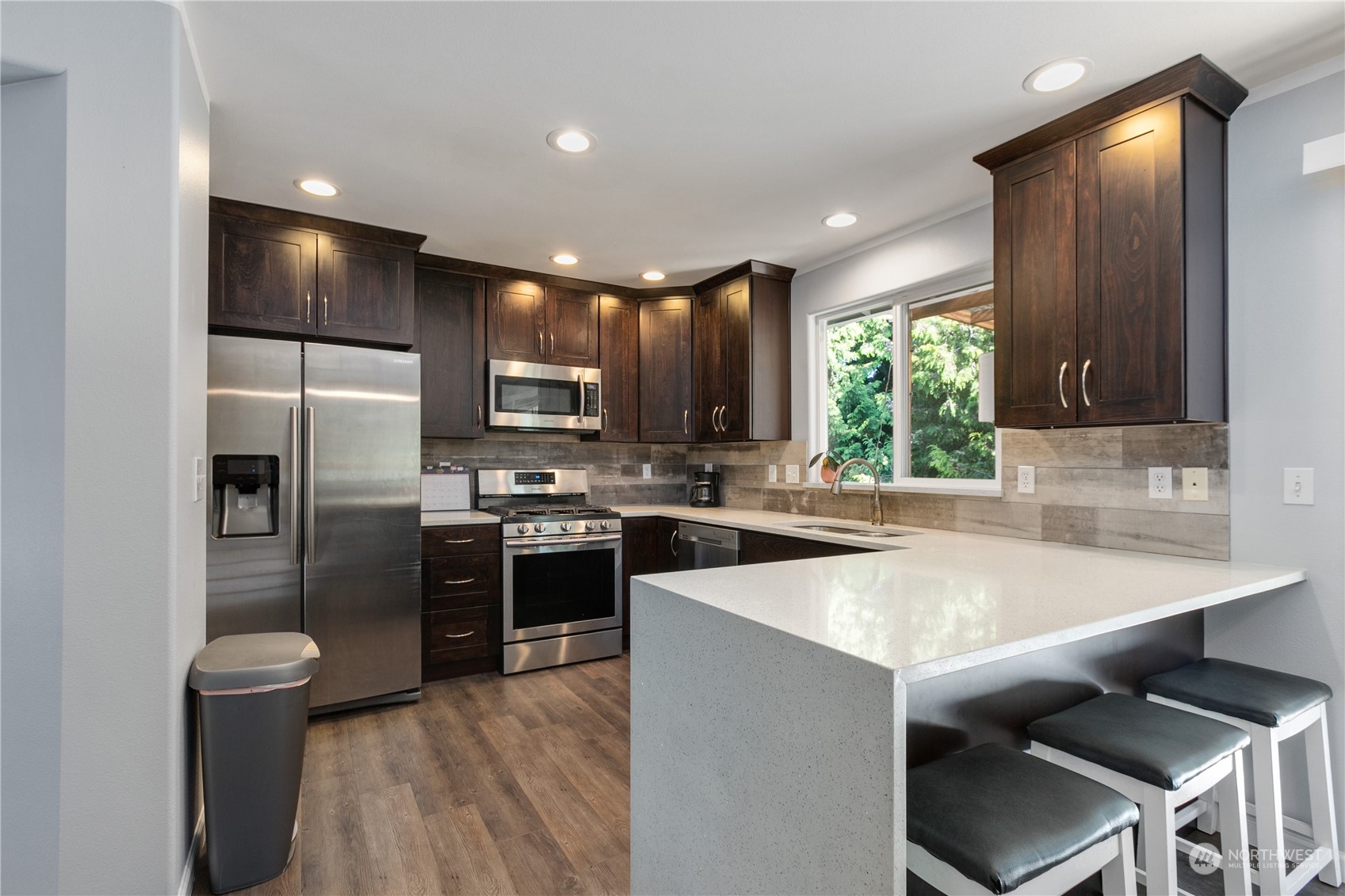 1117 58th Place Southwest Everett, WA 98203 - Photo 7 of 25 a kitchen with kitchen island a sink appliances and cabinets