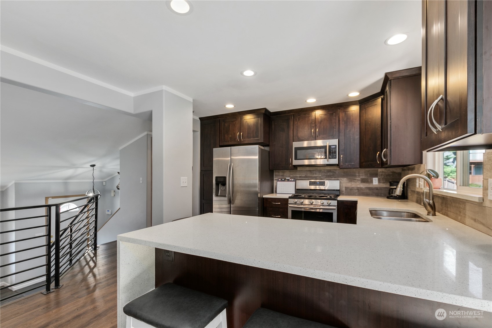1117 58th Place Southwest Everett, WA 98203 - Photo 8 of 25 a kitchen with stainless steel appliances a refrigerator a sink a stove a microwave oven a sink with island and chairs