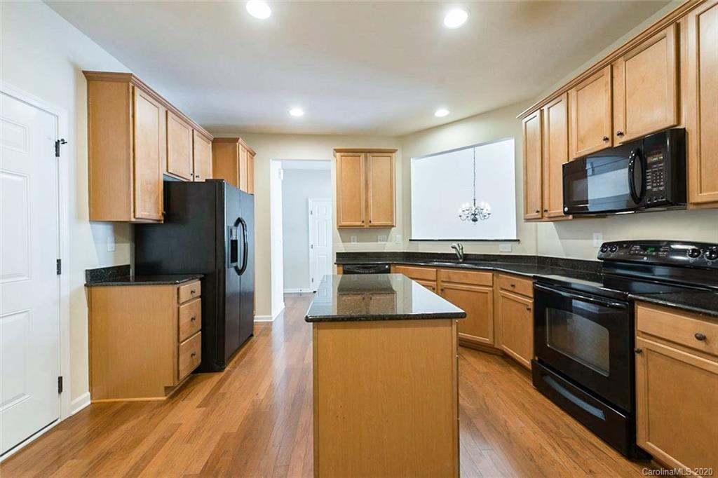 130 Inlet Point Drive Tega Cay, SC 29708 - Photo 2 of 13 a kitchen with stainless steel appliances granite countertop a refrigerator stove microwave and sink