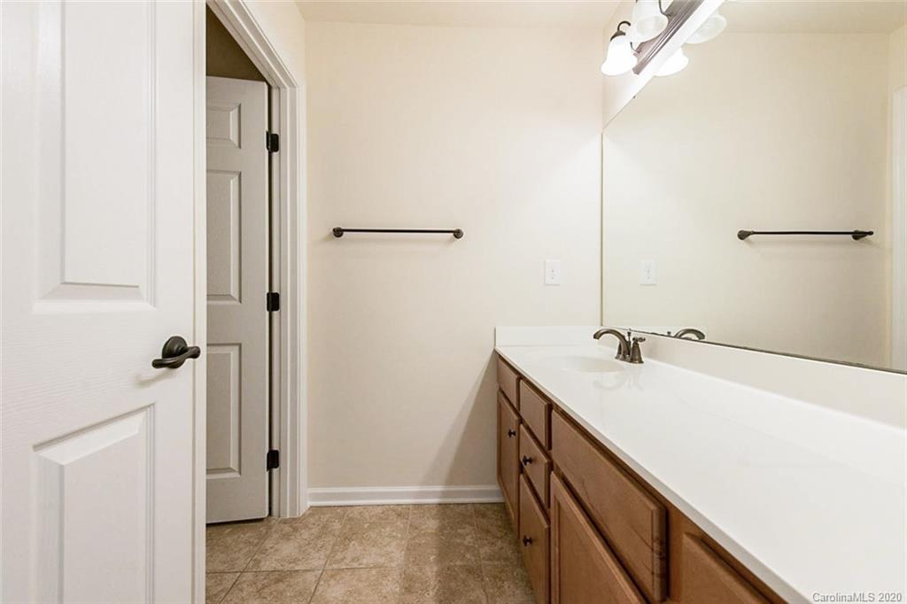 130 Inlet Point Drive Tega Cay, SC 29708 - Photo 12 of 13 a bathroom with a sink and mirror