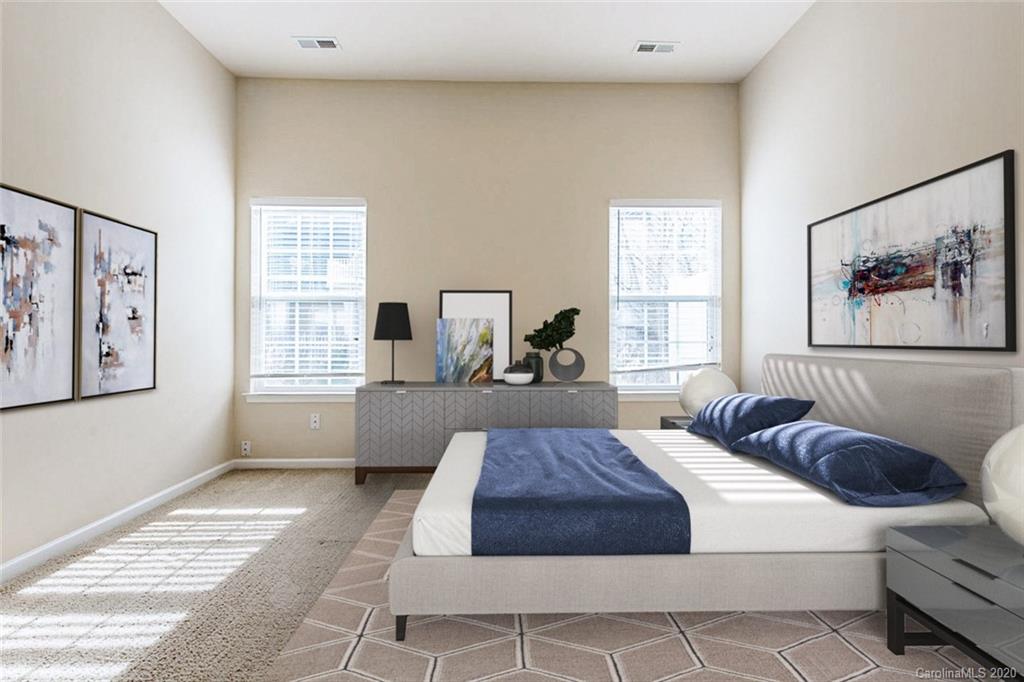 130 Inlet Point Drive Tega Cay, SC 29708 - Photo 4 of 13 a spacious bedroom with a large bed and a window