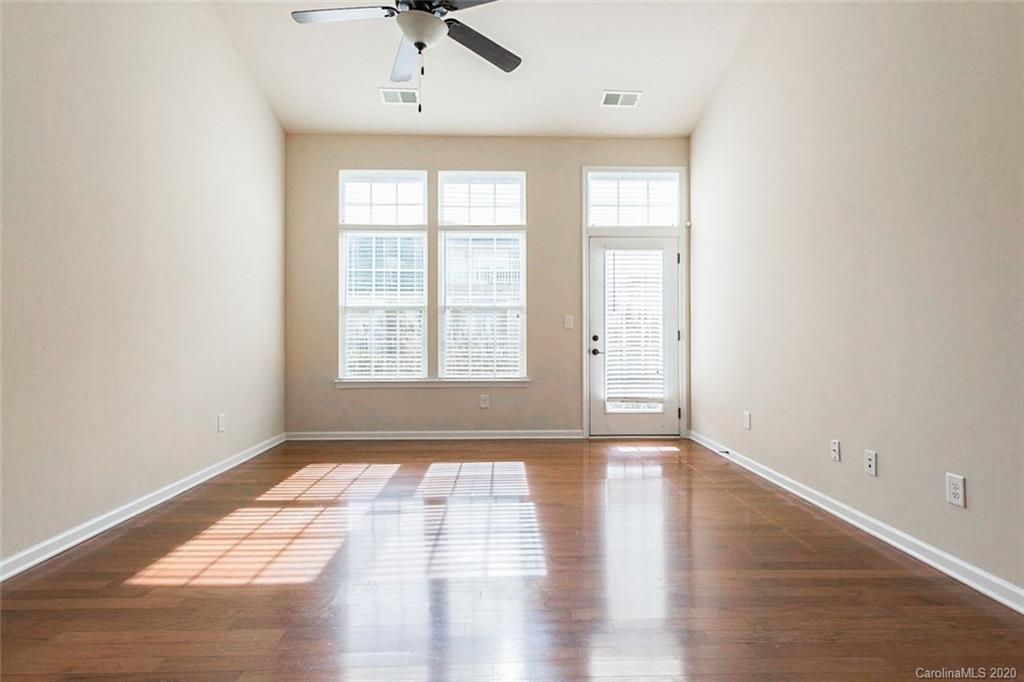 130 Inlet Point Drive Tega Cay, SC 29708 - Photo 8 of 13 wooden floor in an empty room with a window