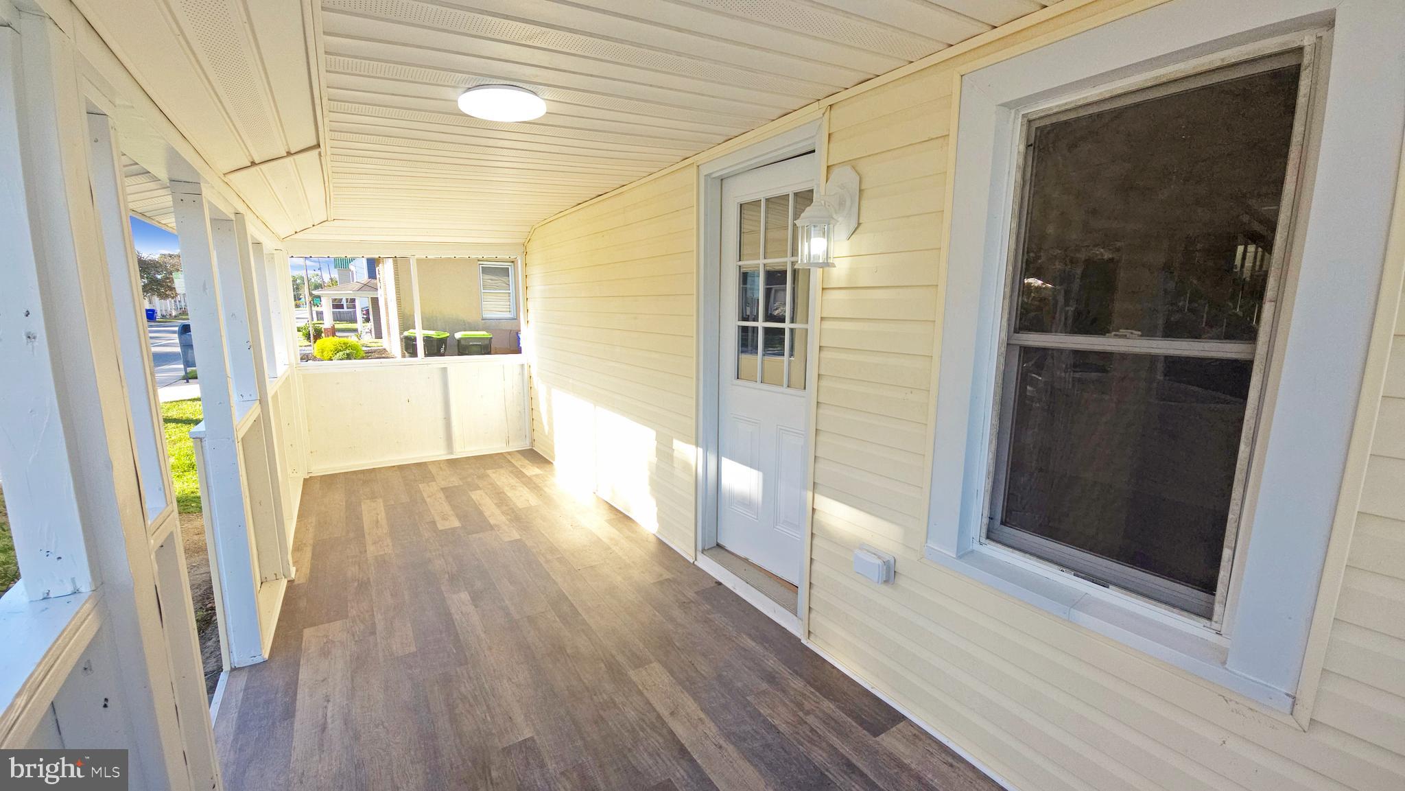 233 Main Street Hartly, DE 19953 - Photo 13 of 26 a view of a hallway with wooden floor and staircase