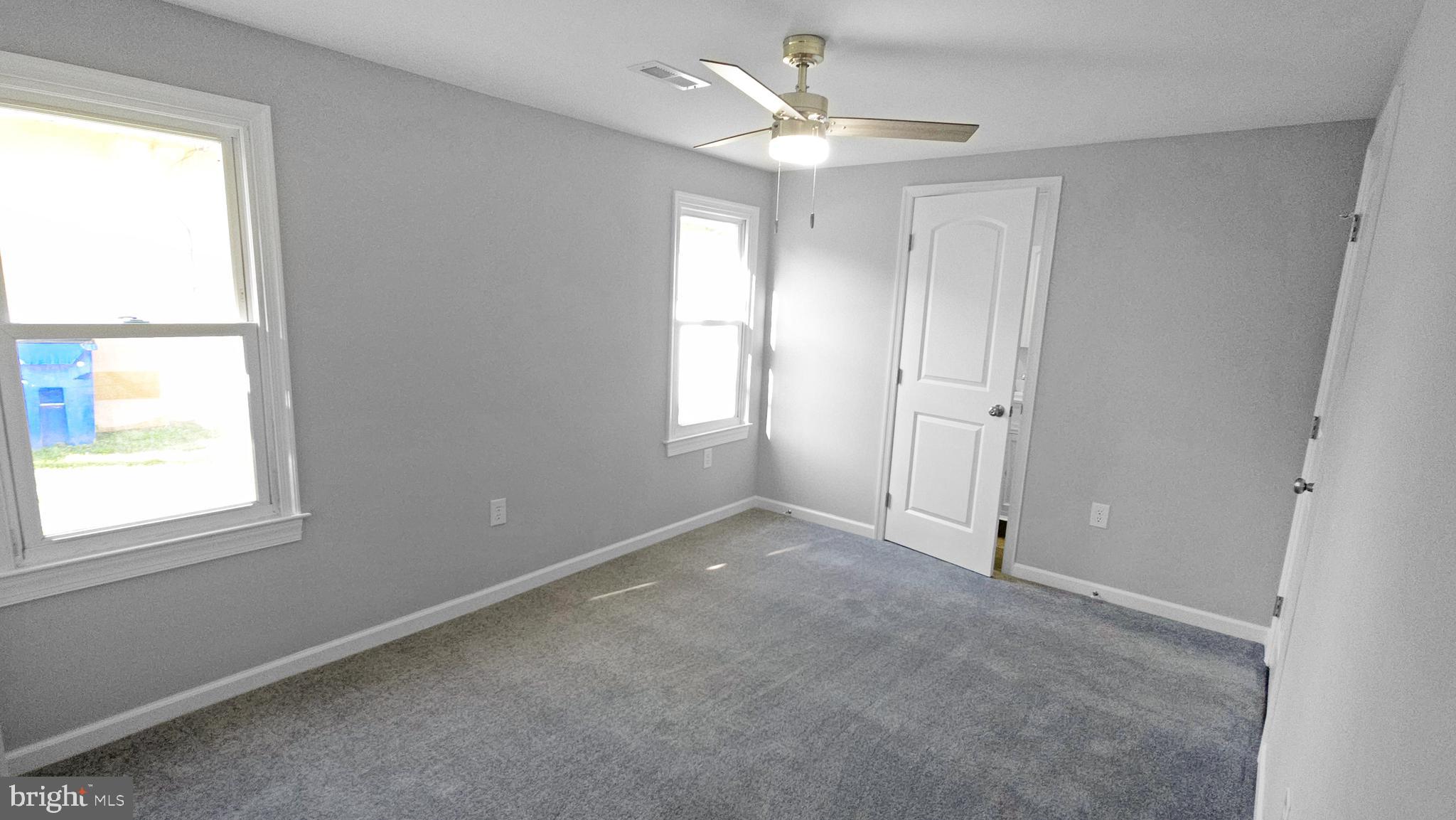 233 Main Street Hartly, DE 19953 - Photo 21 of 26 an empty room with a window and a fan