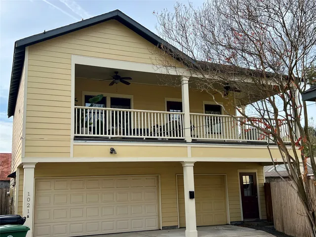 a view of a yard with wooden fence