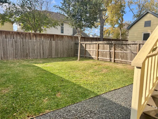 a view of a porch with furniture and a yard