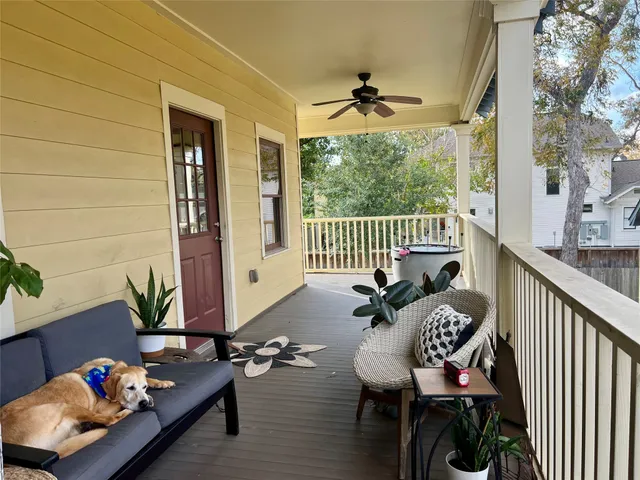 a view of a balcony with chairs and a potted plant