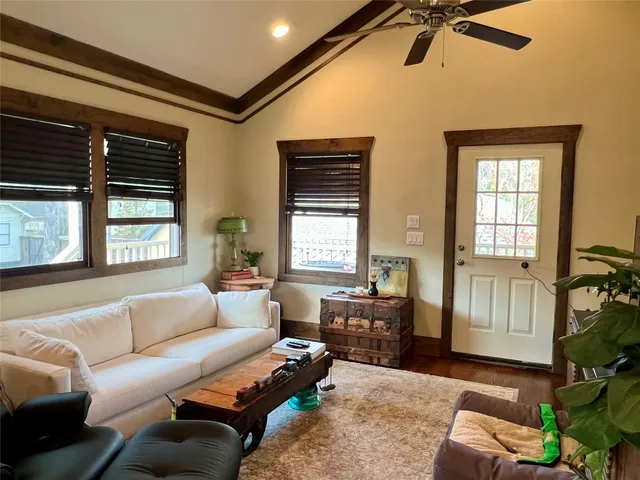 a living room with furniture plant and a window