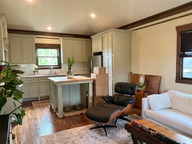 a kitchen with stainless steel appliances kitchen island granite countertop a sink stove and refrigerator