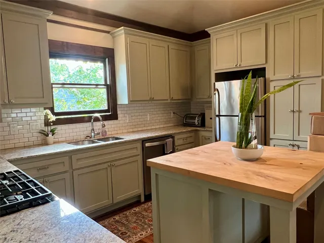 a kitchen with a sink stove and cabinets