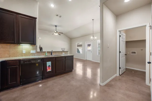 a kitchen with stainless steel appliances granite countertop a refrigerator a sink and a stove