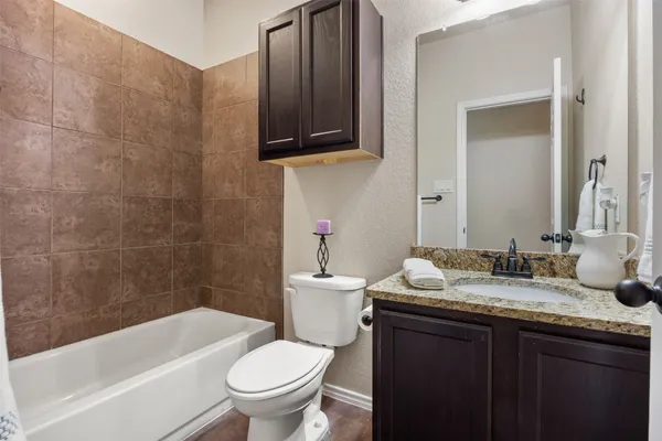 a kitchen with kitchen island granite countertop a sink cabinets and stainless steel appliances