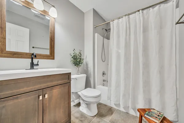 a bathroom with a toilet a sink and a mirror