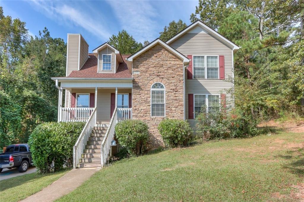 203 Bay Springs Road Villa Rica, GA 30180 - Photo 1 of 1 a front view of a house with yard and green space