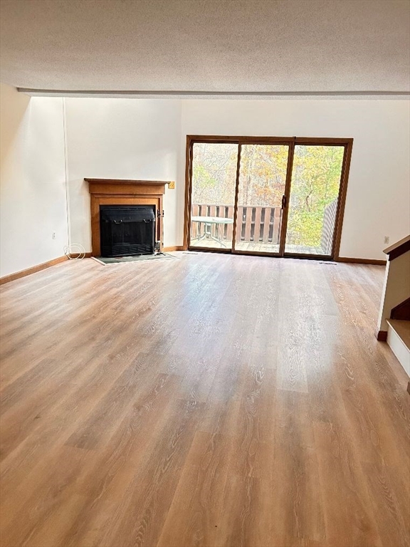 15 A Hawthorne Village, Unit D Franklin, MA 02038 - Photo 12 of 18 a view of an empty room with a fireplace and a window