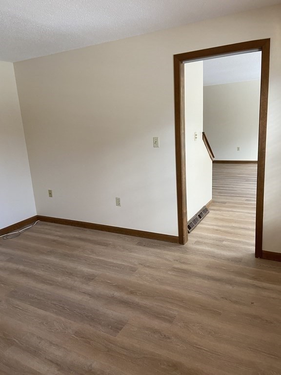 15 A Hawthorne Village, Unit D Franklin, MA 02038 - Photo 13 of 18 a view of an empty room with wooden floor and a window