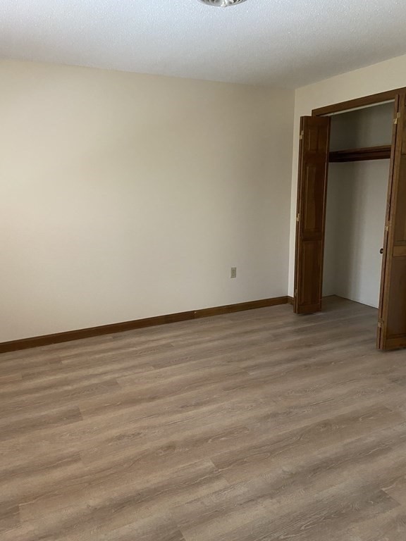 15 A Hawthorne Village, Unit D Franklin, MA 02038 - Photo 15 of 18 a view of an empty room and wooden floor