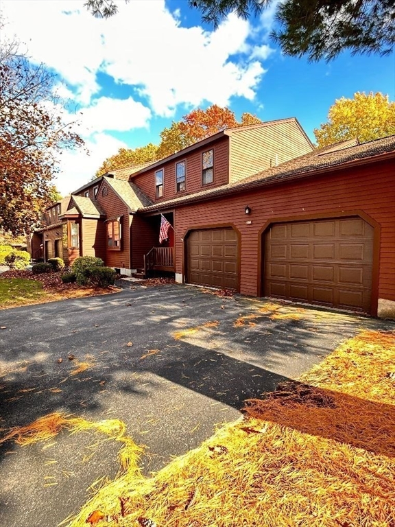 15 A Hawthorne Village, Unit D Franklin, MA 02038 - Photo 2 of 18 a front view of a house with a yard