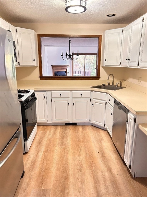 15 A Hawthorne Village, Unit D Franklin, MA 02038 - Photo 8 of 18 a kitchen with granite countertop a sink cabinets stainless steel appliances and a window