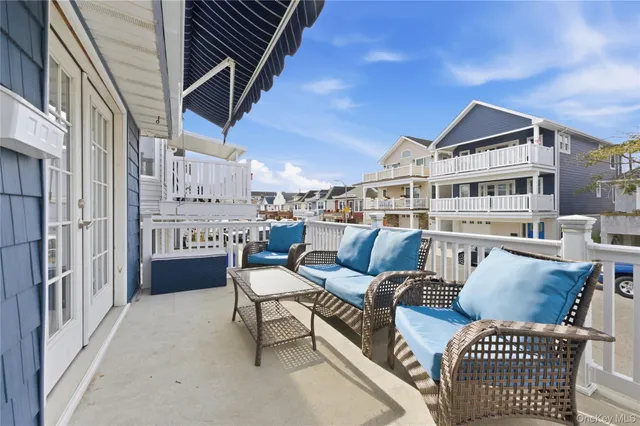 a view of a chairs and table in the balcony