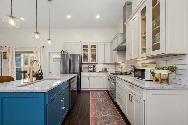 a kitchen with a sink stove and refrigerator