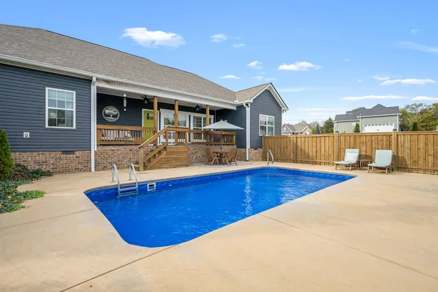 a view of a house with swimming pool and sitting area