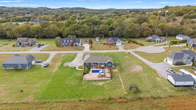 a view of a house with swimming pool and yard