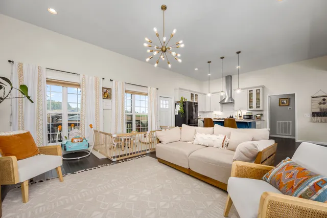 a living room with furniture and a chandelier