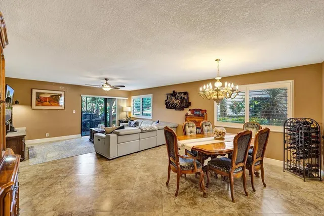 a view of a dining room with furniture and chandelier