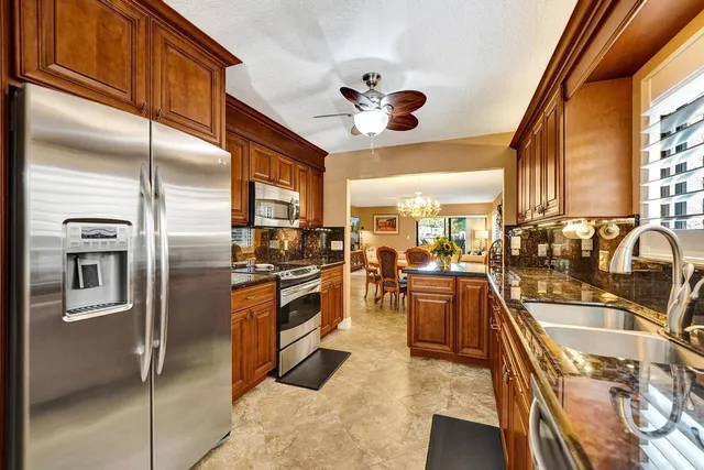 a kitchen with stainless steel appliances granite countertop a stove and a sink