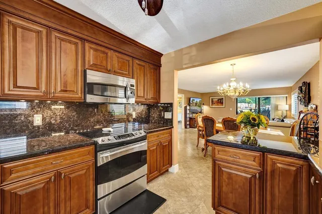 a bathroom with a granite countertop toilet sink and mirror