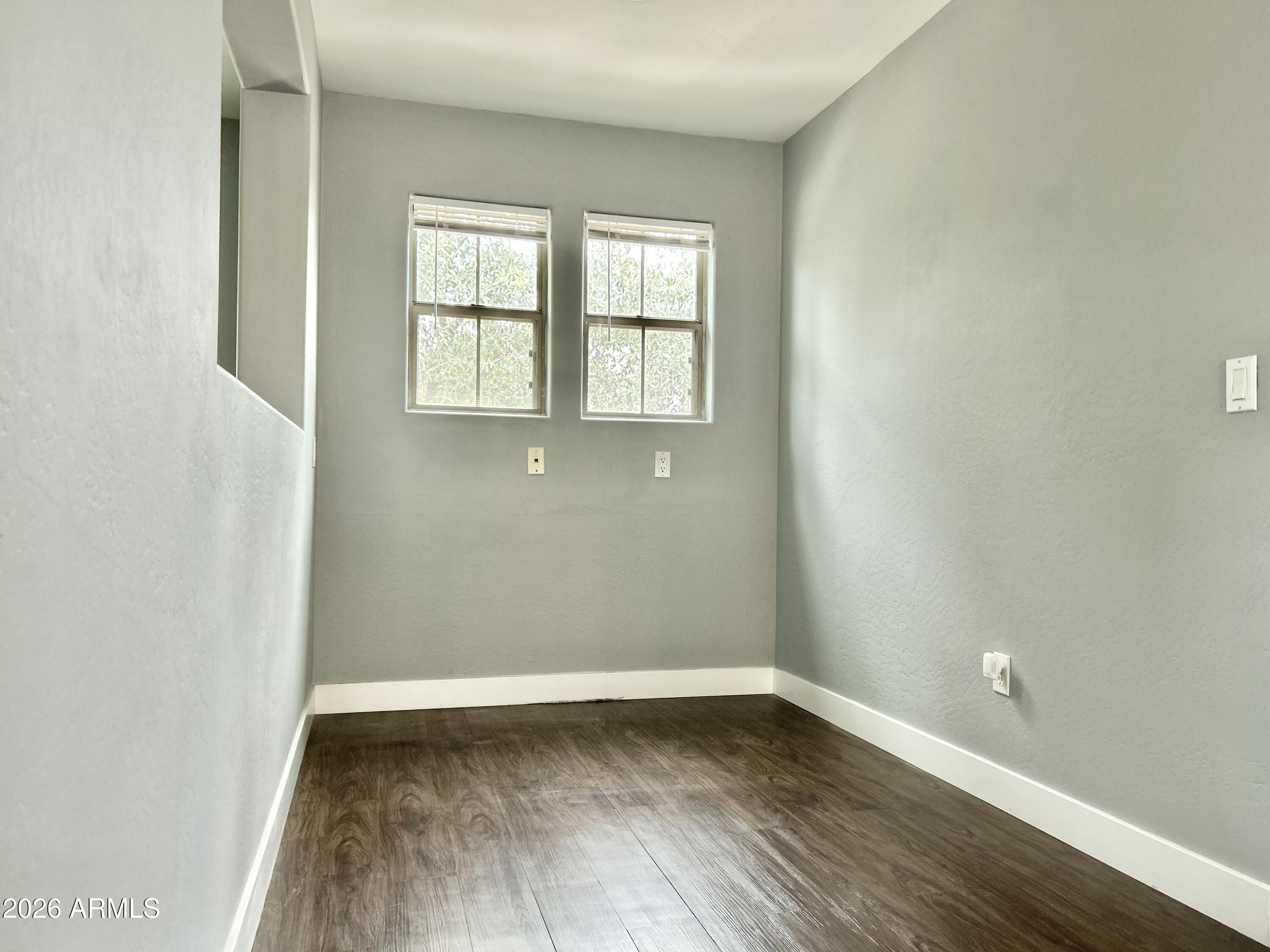 451 South Hawes Road, Unit 43 Mesa, AZ 85208 - Photo 11 of 23 an empty room with wooden floor and windows