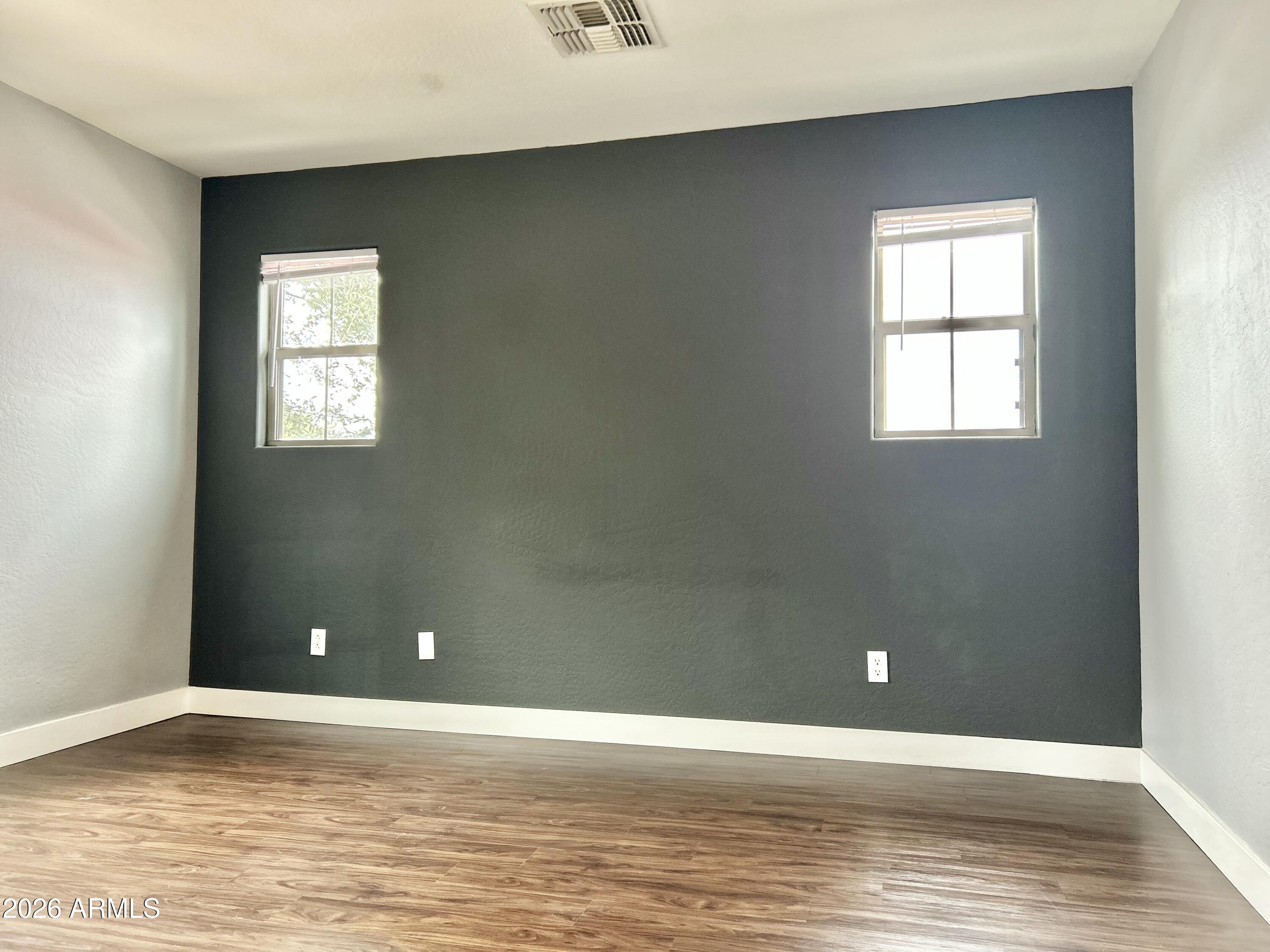 451 South Hawes Road, Unit 43 Mesa, AZ 85208 - Photo 15 of 23 a view of an empty room with window and wooden floor