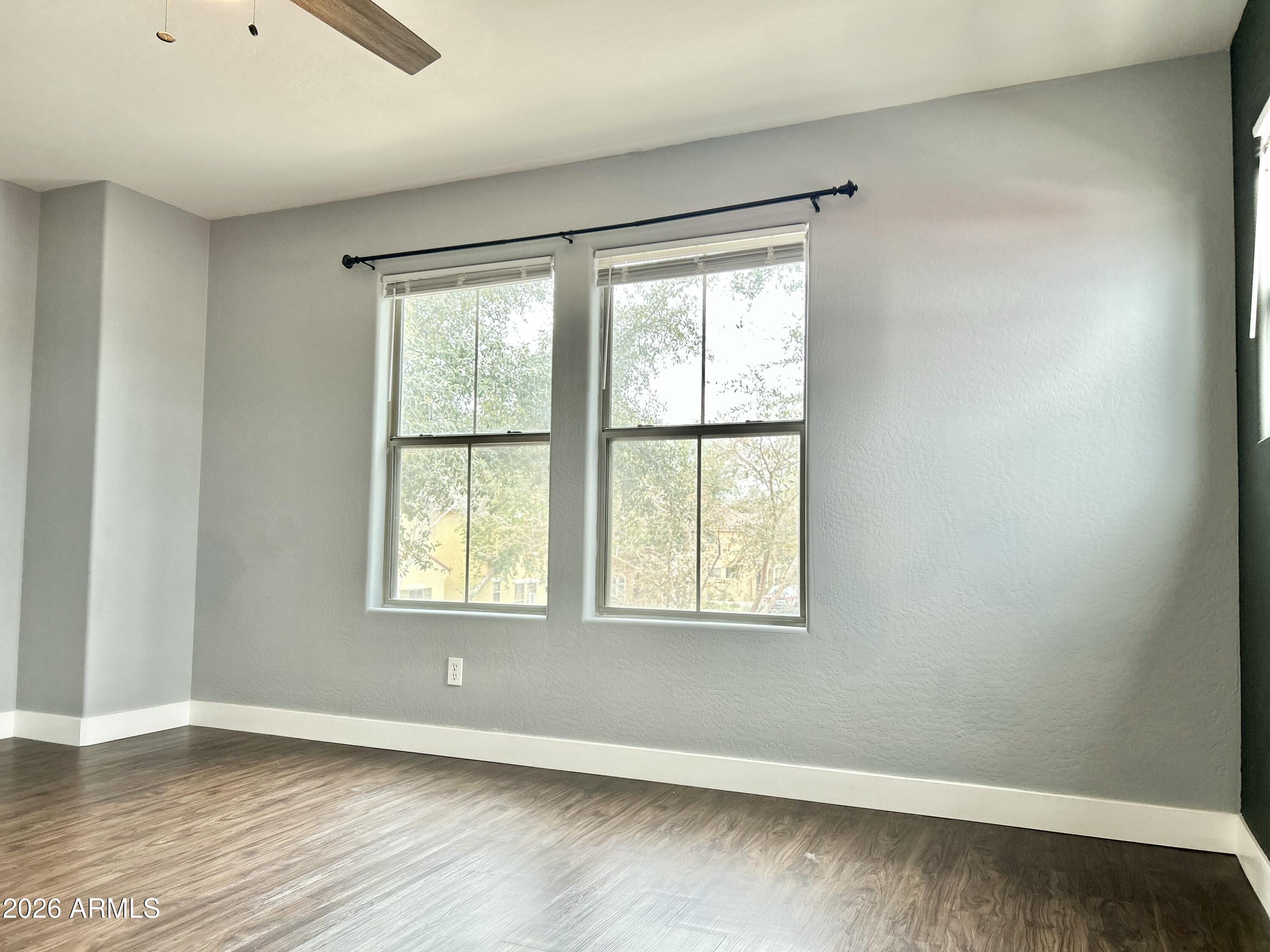 451 South Hawes Road, Unit 43 Mesa, AZ 85208 - Photo 16 of 23 an empty room with wooden floor and windows