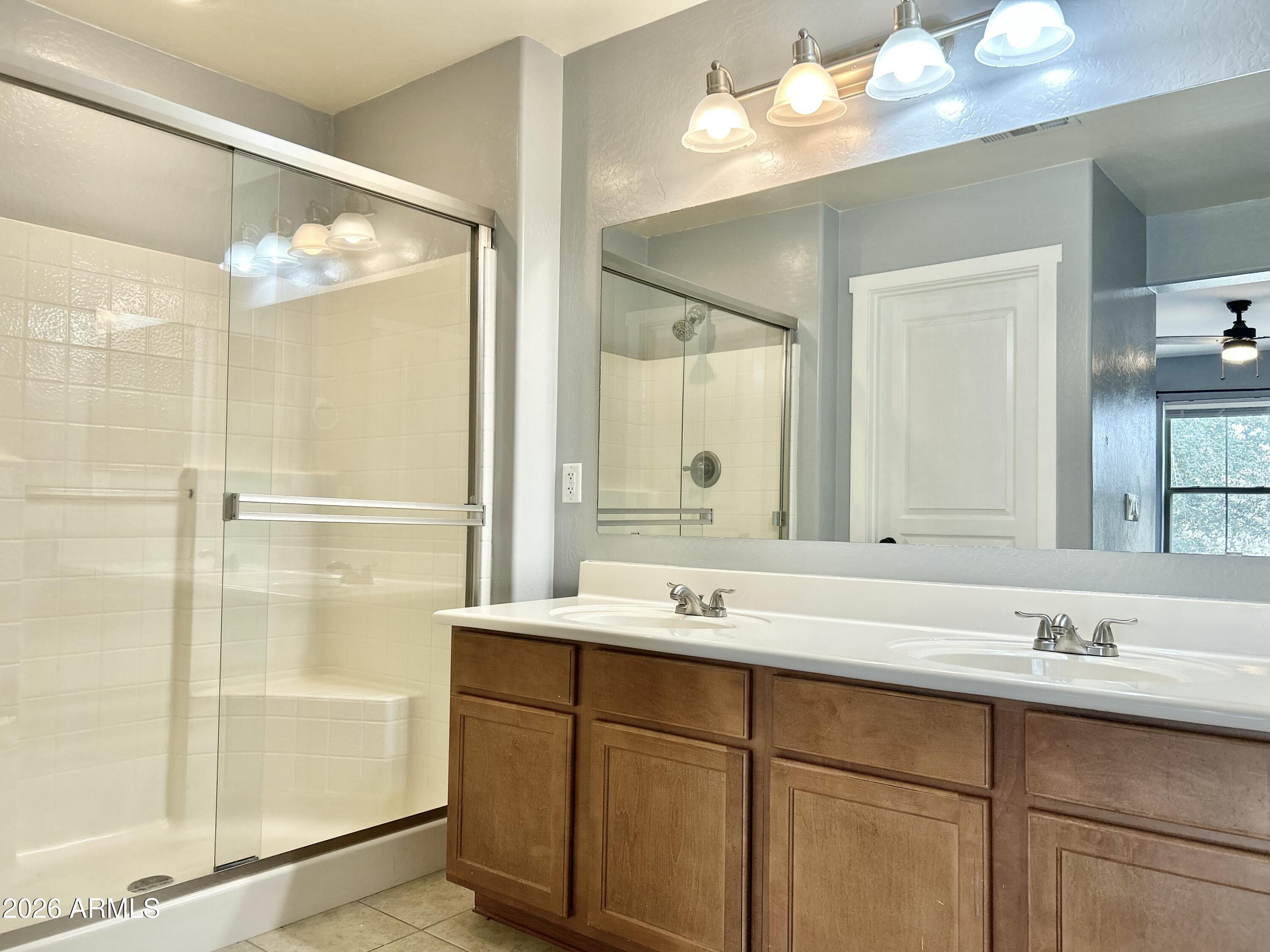 451 South Hawes Road, Unit 43 Mesa, AZ 85208 - Photo 18 of 23 a bathroom with a double vanity sink mirror and shower