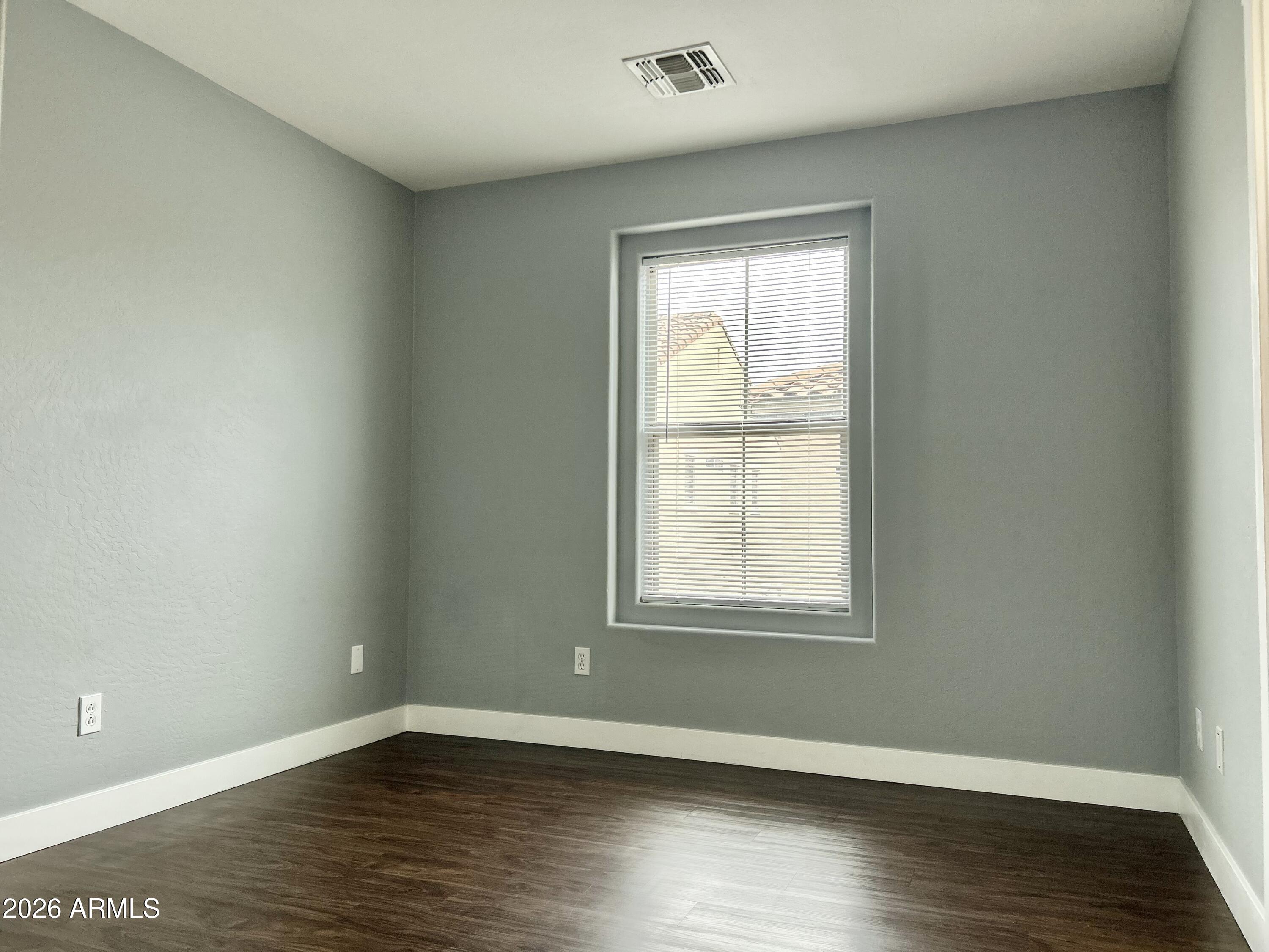 451 South Hawes Road, Unit 43 Mesa, AZ 85208 - Photo 19 of 23 an empty room with wooden floor and windows
