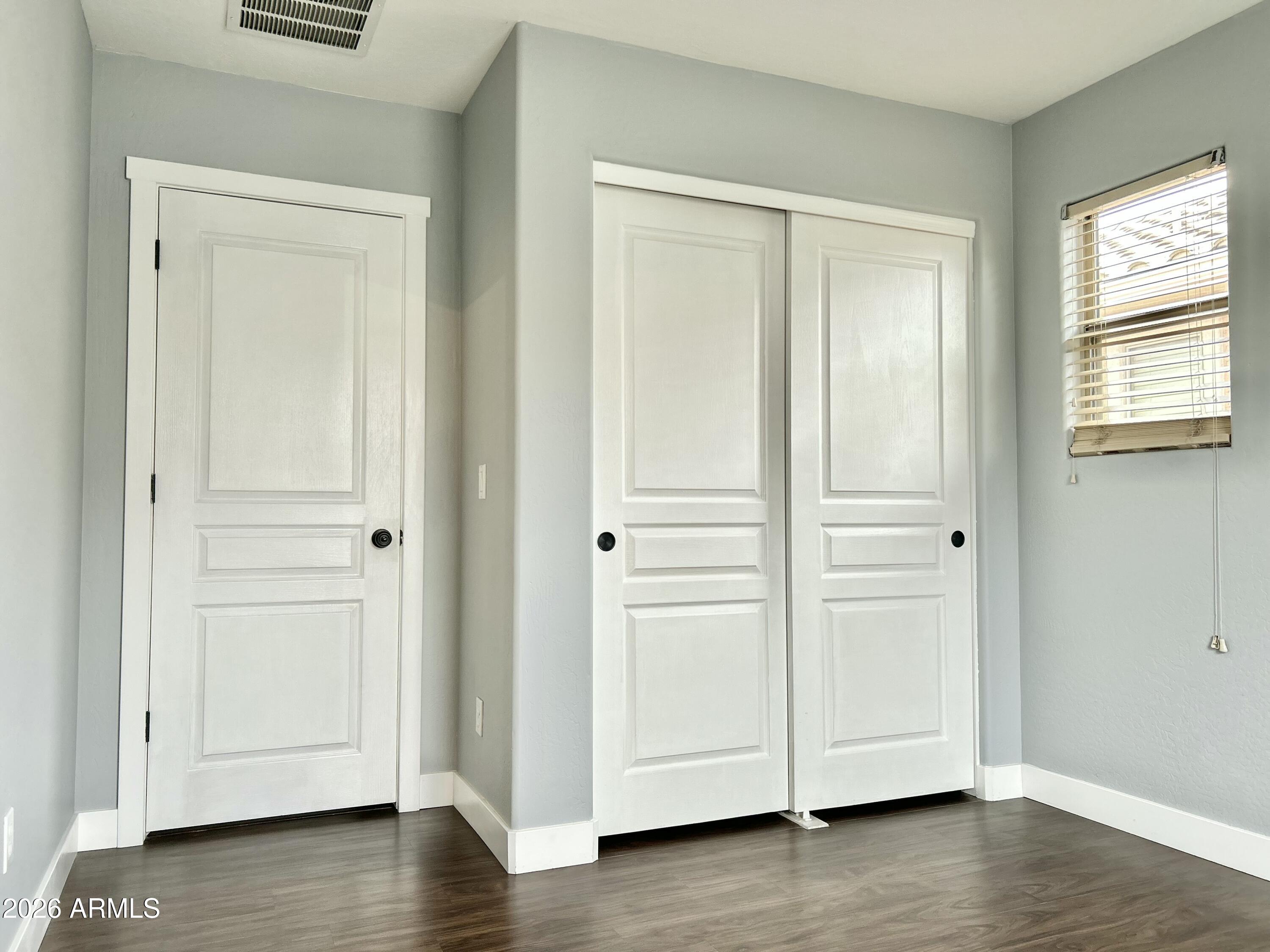 451 South Hawes Road, Unit 43 Mesa, AZ 85208 - Photo 20 of 23 an empty room with wooden floor & closet area