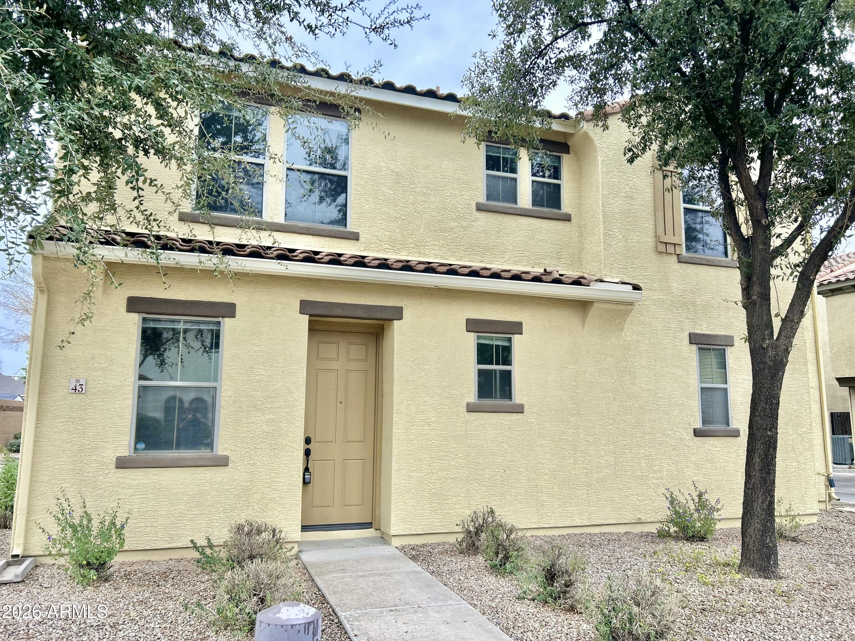 451 South Hawes Road, Unit 43 Mesa, AZ 85208 - Photo 2 of 23 a front view of a house with a garden