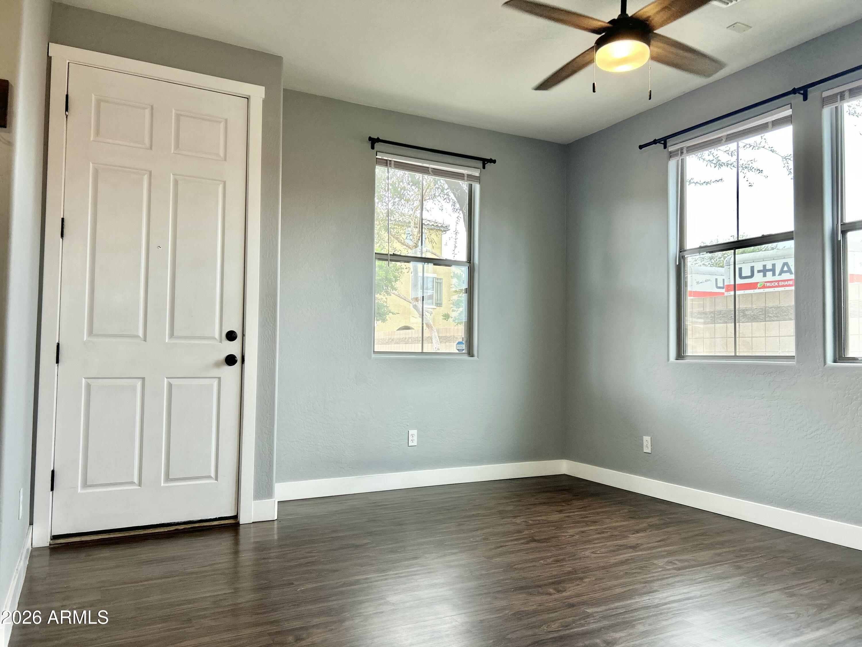451 South Hawes Road, Unit 43 Mesa, AZ 85208 - Photo 3 of 23 a view of an empty room with wooden floor and a window