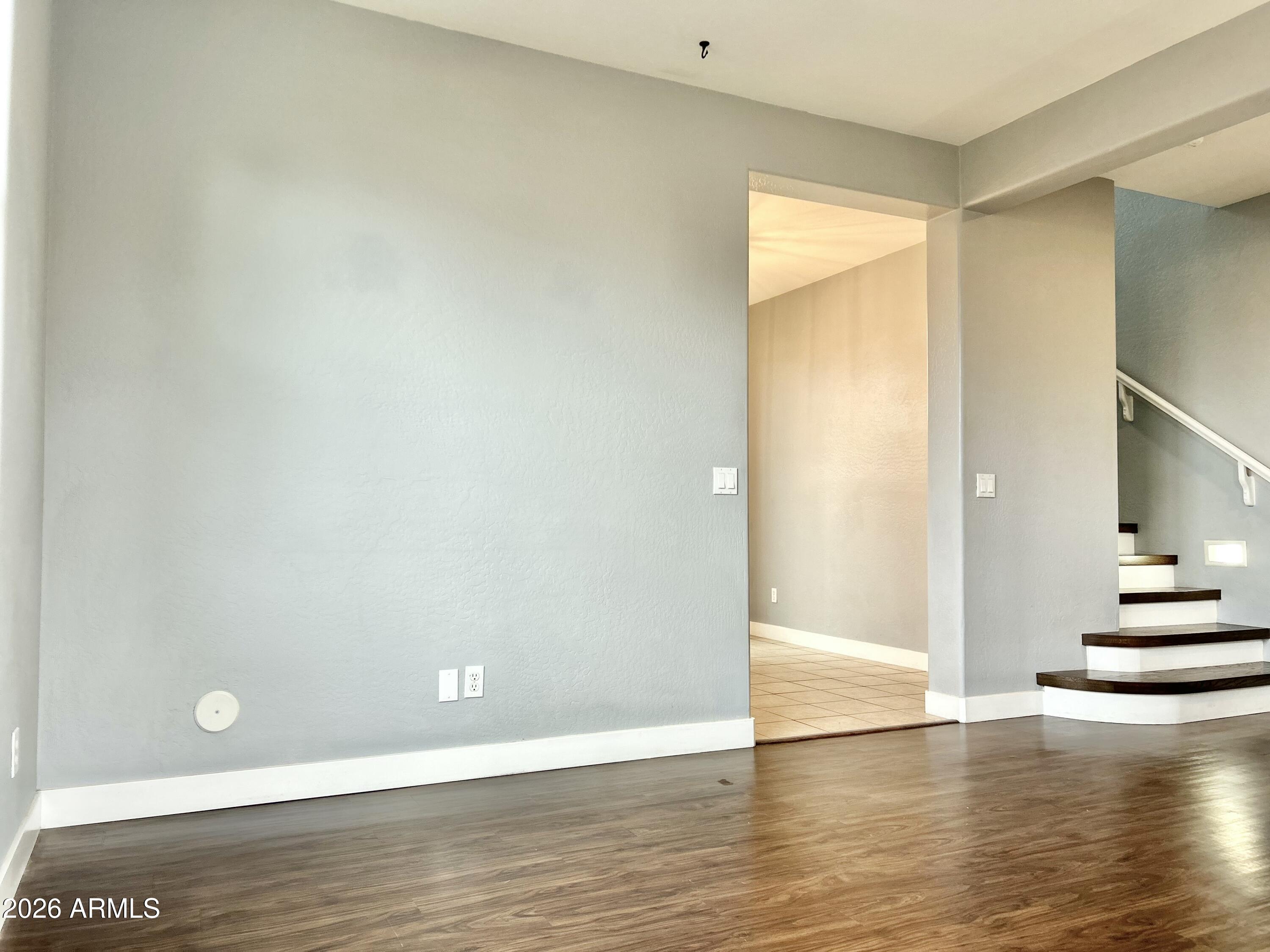 451 South Hawes Road, Unit 43 Mesa, AZ 85208 - Photo 4 of 23 a view of an empty room with wooden floor and a cabinet