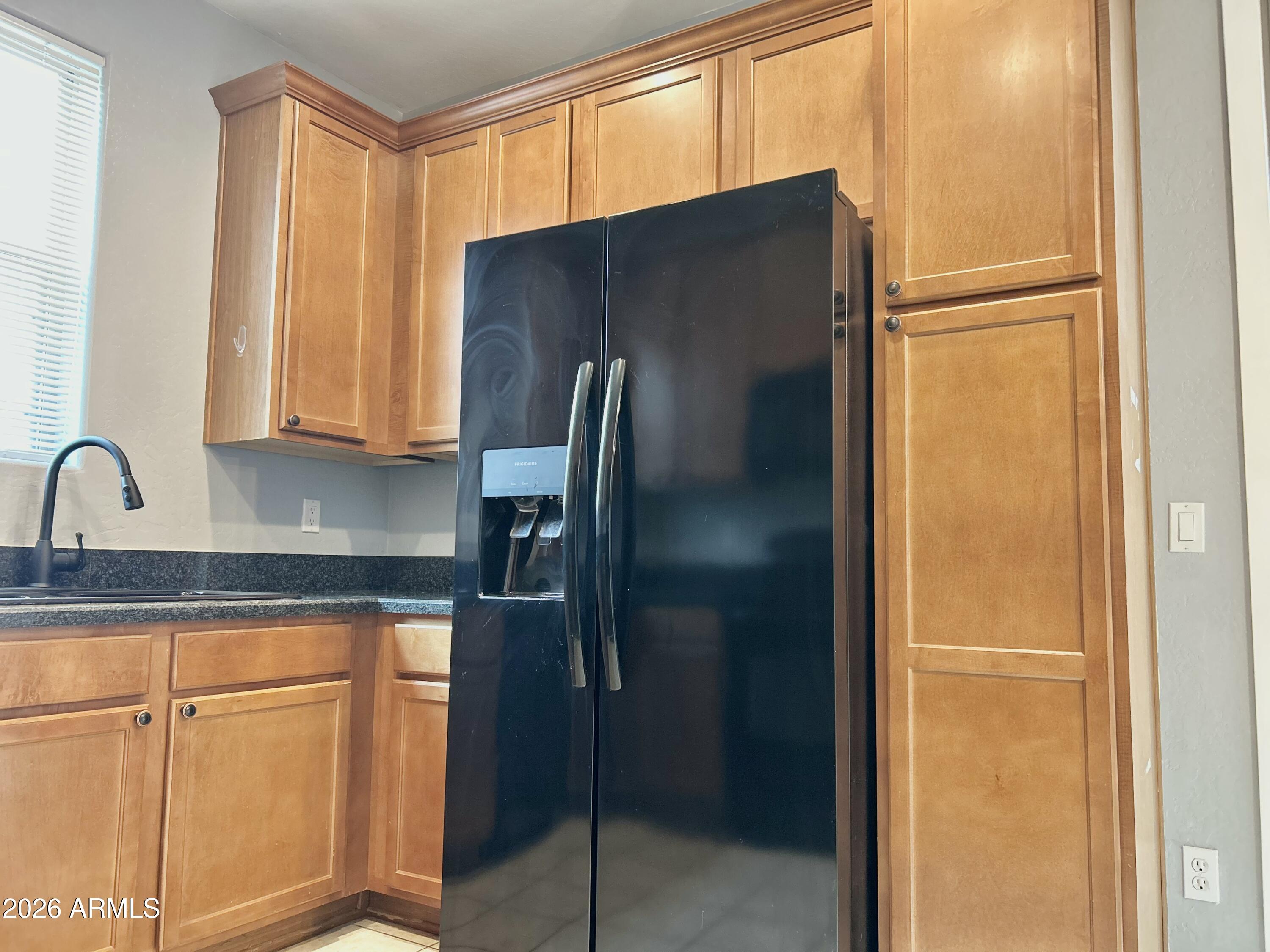 451 South Hawes Road, Unit 43 Mesa, AZ 85208 - Photo 8 of 23 a kitchen with metallic refrigerator freezer and a dishwasher