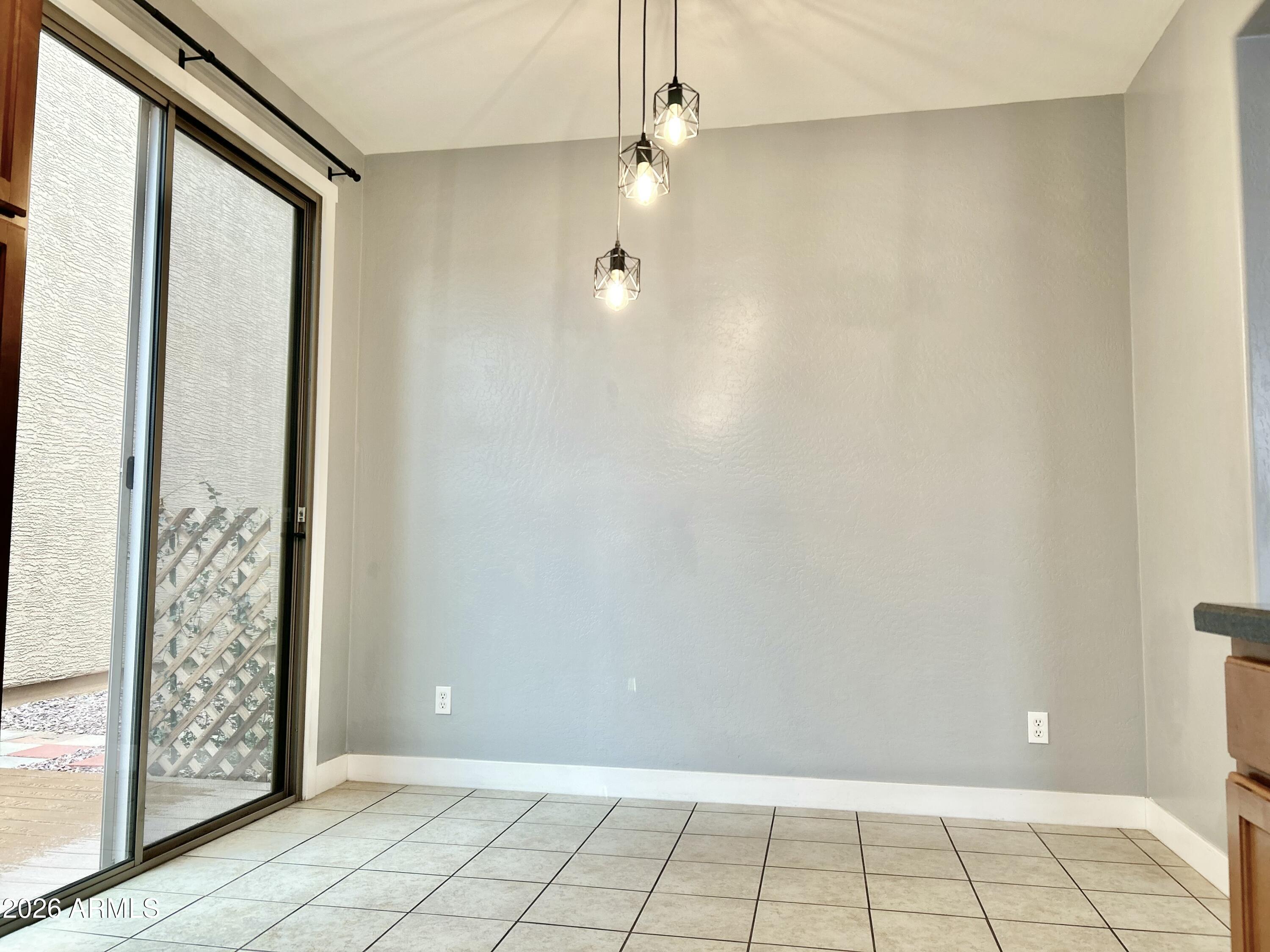 451 South Hawes Road, Unit 43 Mesa, AZ 85208 - Photo 9 of 23 a view of an empty room with window and chandelier fan