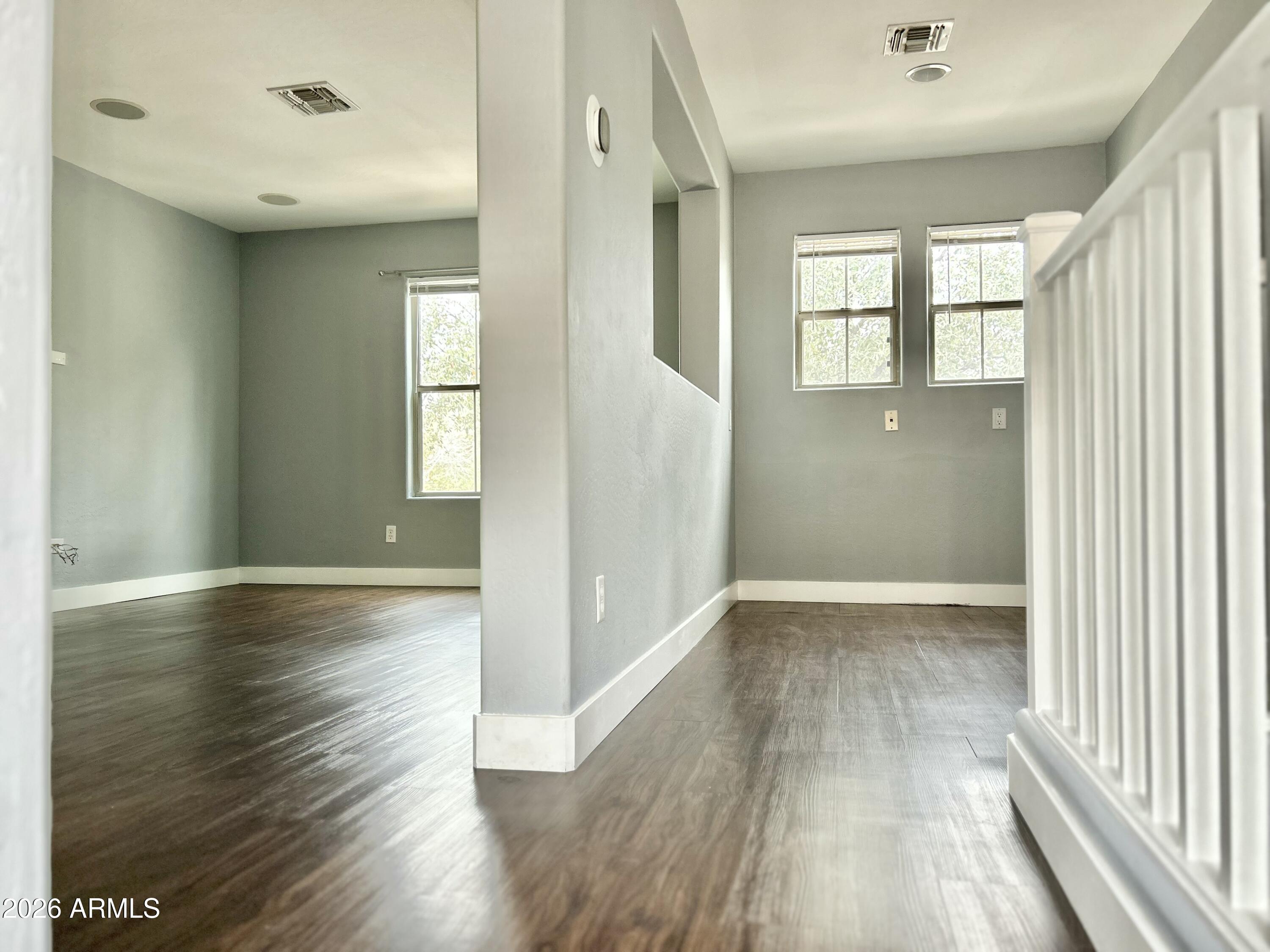 451 South Hawes Road, Unit 43 Mesa, AZ 85208 - Photo 10 of 23 an empty room with wooden floor and windows