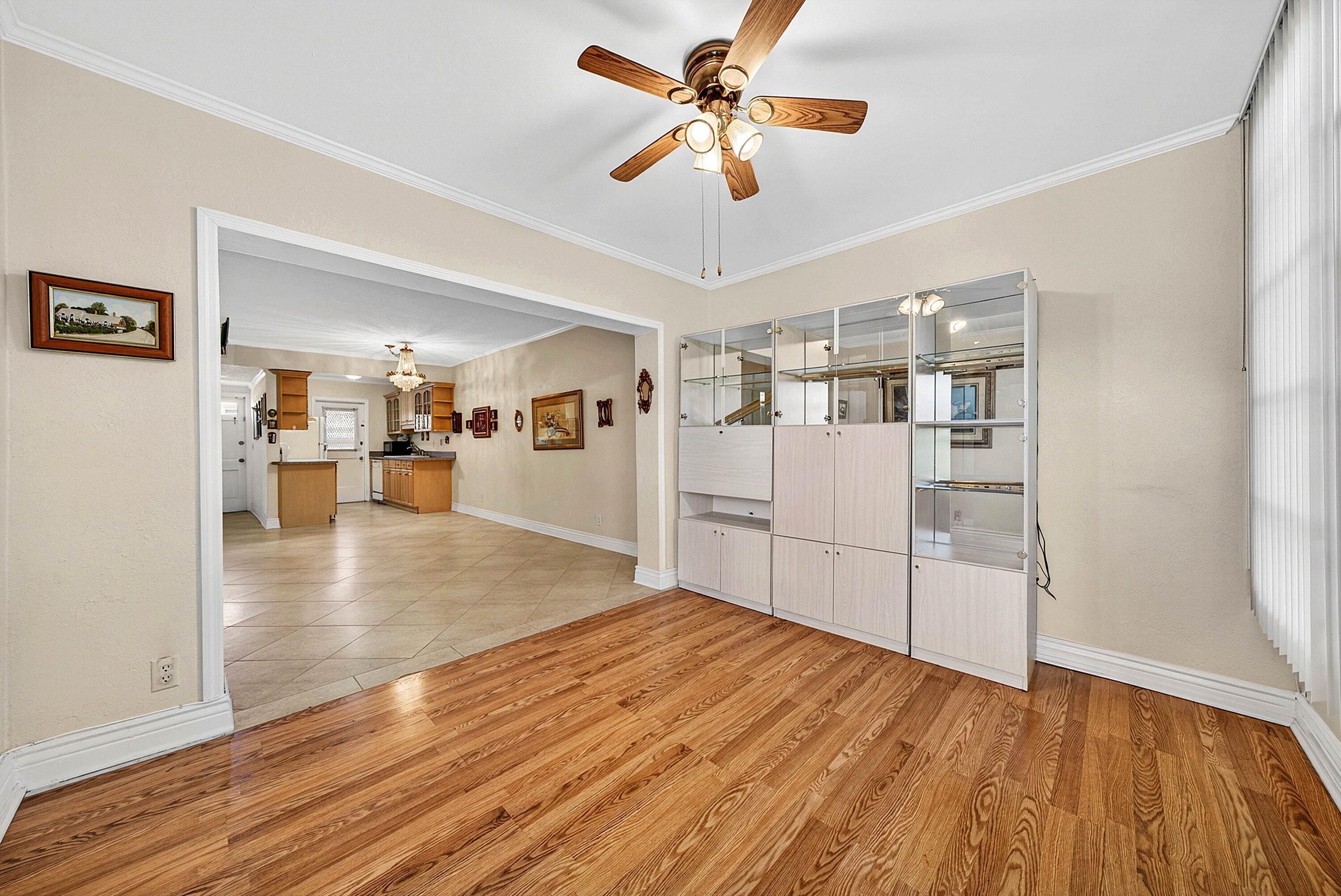 300 Northeast 20th Street, Unit 308 Boca Raton, FL 33431 - Photo 15 of 40 a view of a kitchen with wooden floor and a ceiling fan