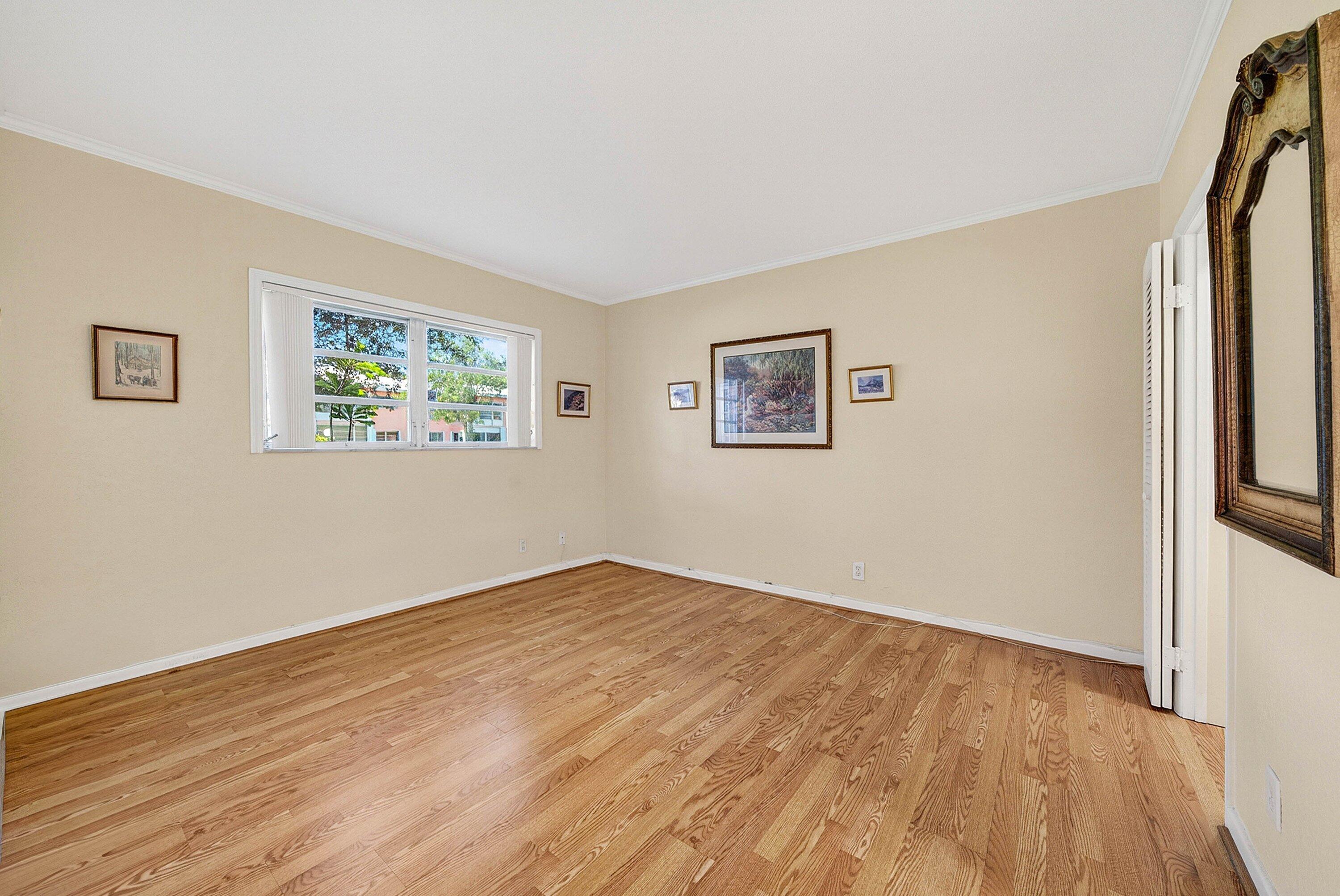 300 Northeast 20th Street, Unit 308 Boca Raton, FL 33431 - Photo 16 of 40 a view of an empty room with wooden floor and a window