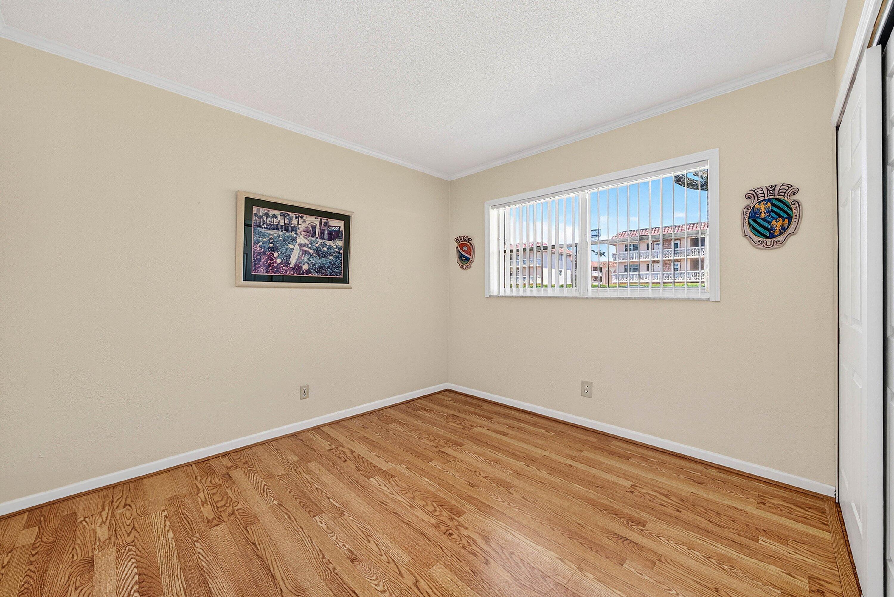 300 Northeast 20th Street, Unit 308 Boca Raton, FL 33431 - Photo 21 of 40 an empty room with a painting on the wall